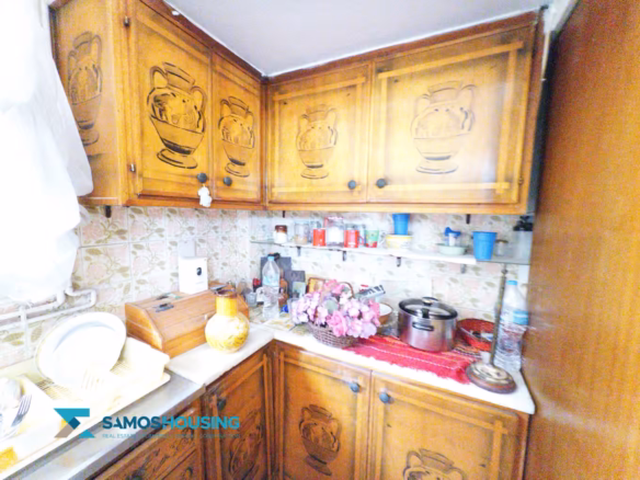 Kitchen with carved wooden cabinets in a duplex apartment in Samos Town, Samos