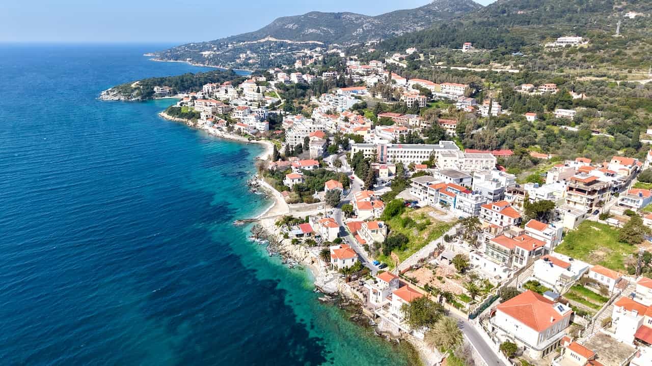 Samos Island coastline with green hills, village houses and the Aegean Sea