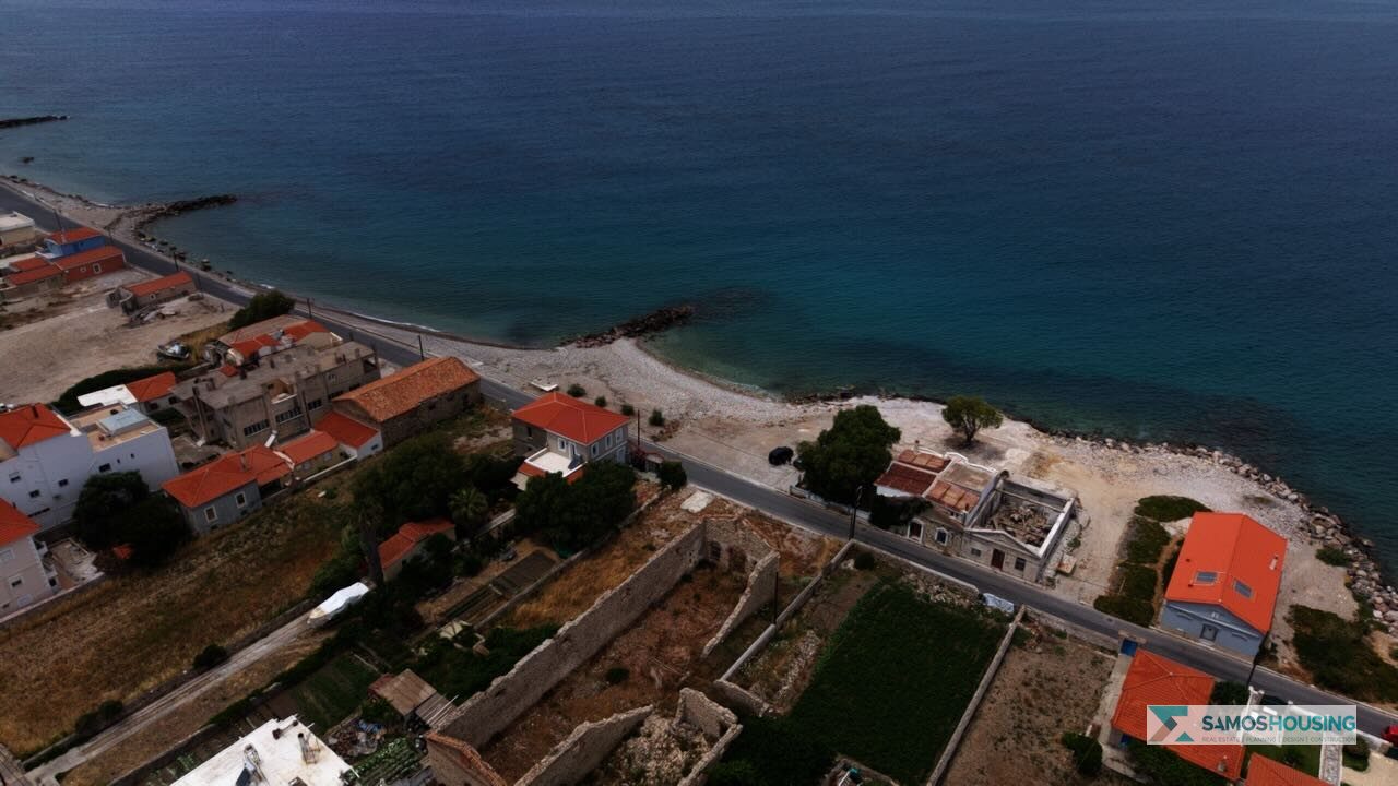 Aerial view of the Karlovasi coastline near the SH589 plot, showing the beach and coast road