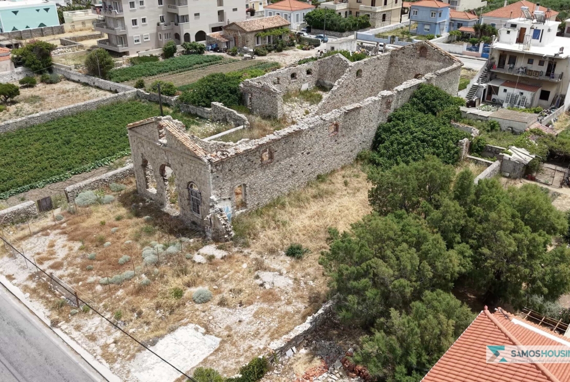 Close aerial view of the roofless stone ruin on the SH589 plot in Karlovasi