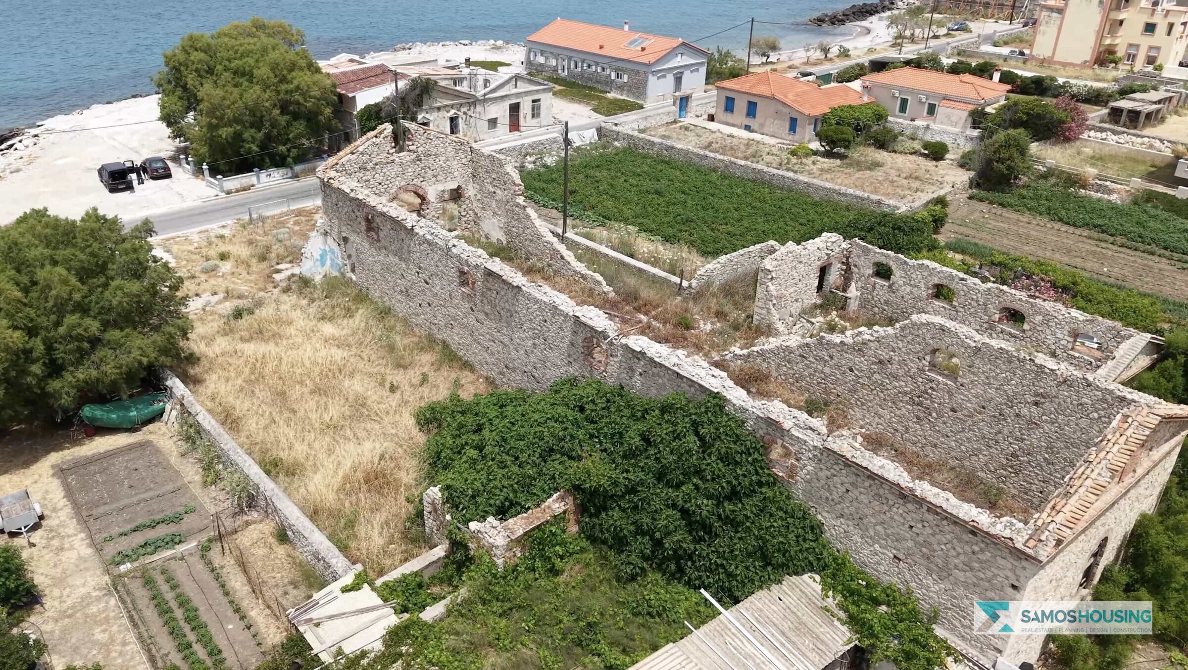 Aerial view of the stone ruin's interior walls on the SH589 plot, near the sea in Karlovasi