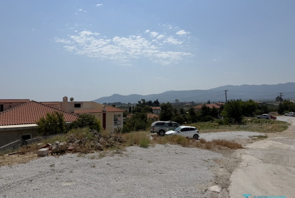Open building ground with the mountain backdrop of Nea Poli, Samos
