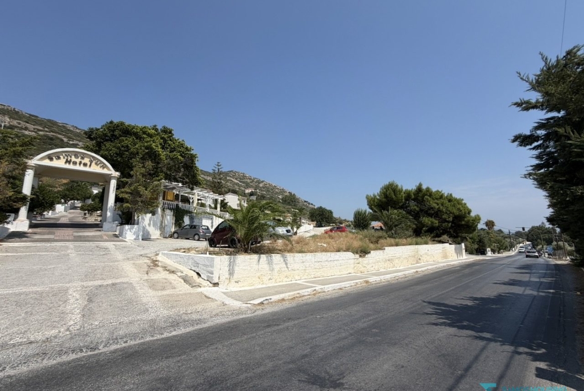 Stone retaining wall and pavement on the road frontage of the parcel, Samos