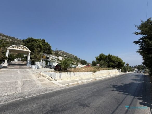 Stone retaining wall and pavement on the road frontage of the parcel, Samos
