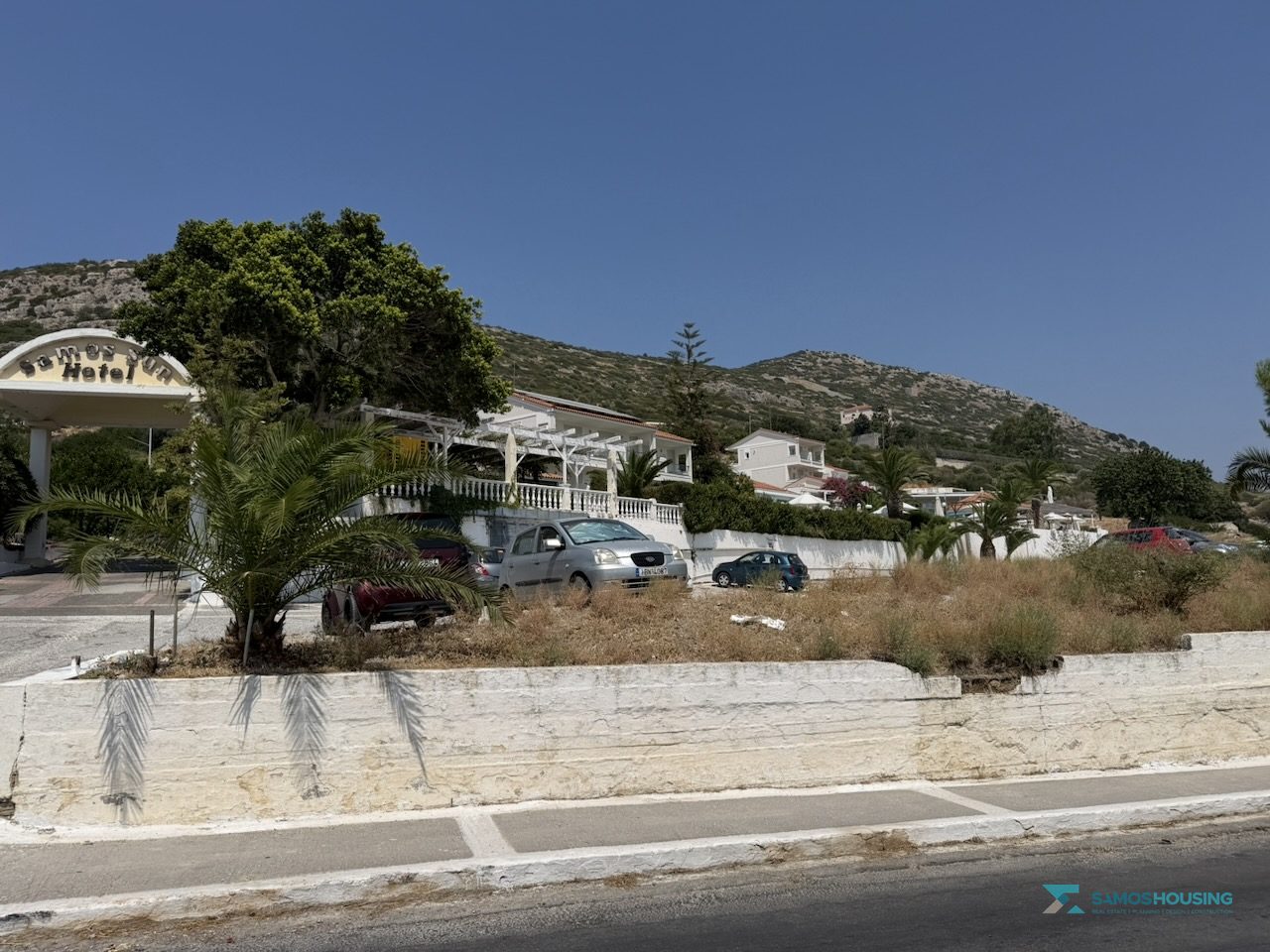 SH591 Land Pythagorio Samos 15 Roadside boundary wall with the hills of Samos behind