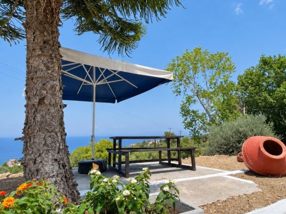 Outdoor seating under a parasol with sea view, Kontakaiika, Samos