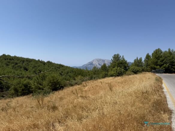 Plot boundary on the asphalt road with Kerkis view, Pyrgos Samos