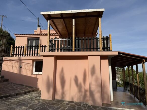 Two-level cottage facade with timber balcony, Stavrinides village, Samos