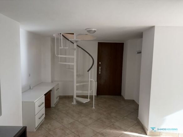 Ground-floor hall with white spiral staircase, Stavrinides, Samos