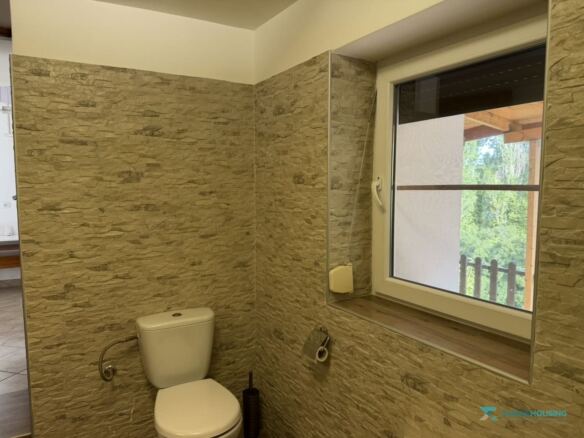 Bathroom with stone-effect wall tiles and window, Stavrinides cottage