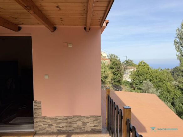 Side entrance under the timber pergola with view toward the sea, Samos