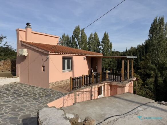 Cottage exterior with tiled roof and paved courtyard, Stavrinides