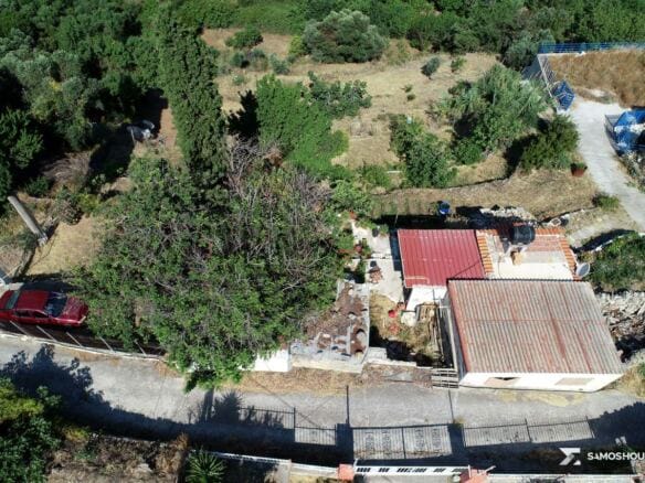 Aerial view of the plot with the stone outbuilding beside the village road